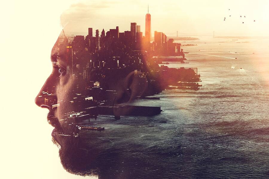 The profile of a woman's head, a New York City skyline double exposed with the image. A conceptual depiction of smart cities, and the people who shape them.