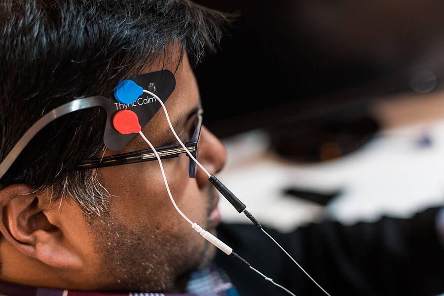 LOS GATOS, CA - MARCH, 24: Sumon Pal, Chief of Vibes at Thync, tests a prototype Thync module at his desk at Thync's headquarters. The module sends low energy waveforms that energize or relax users by simulating neck and head nerves. 2016. (Photo by Ryan C. Jones/For The Washington Post via Getty Images)